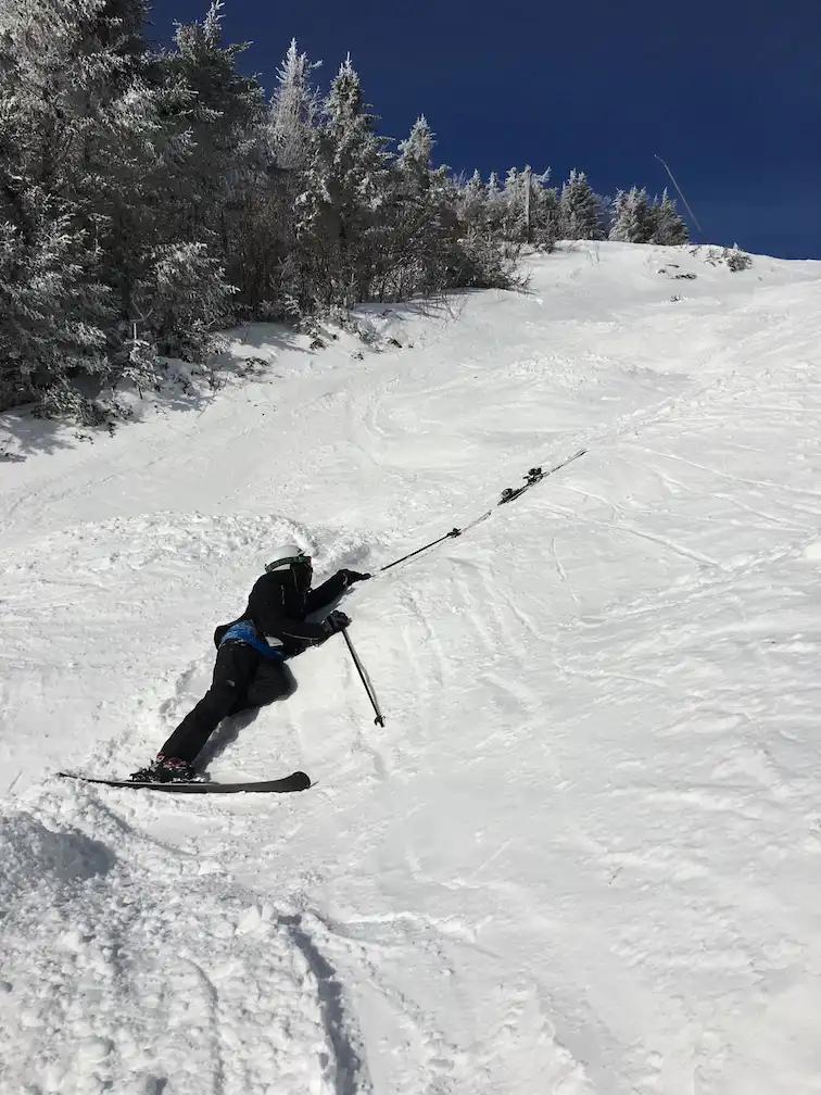 Mohammed fallen on a ski hill trying to reach his ski pole